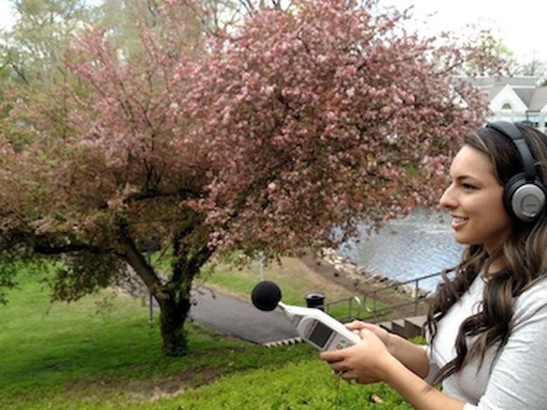 Student doing research while facing the duck pond